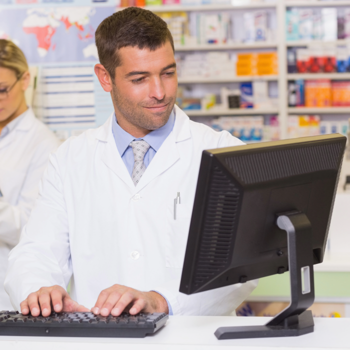 male pharmacist in front of computer